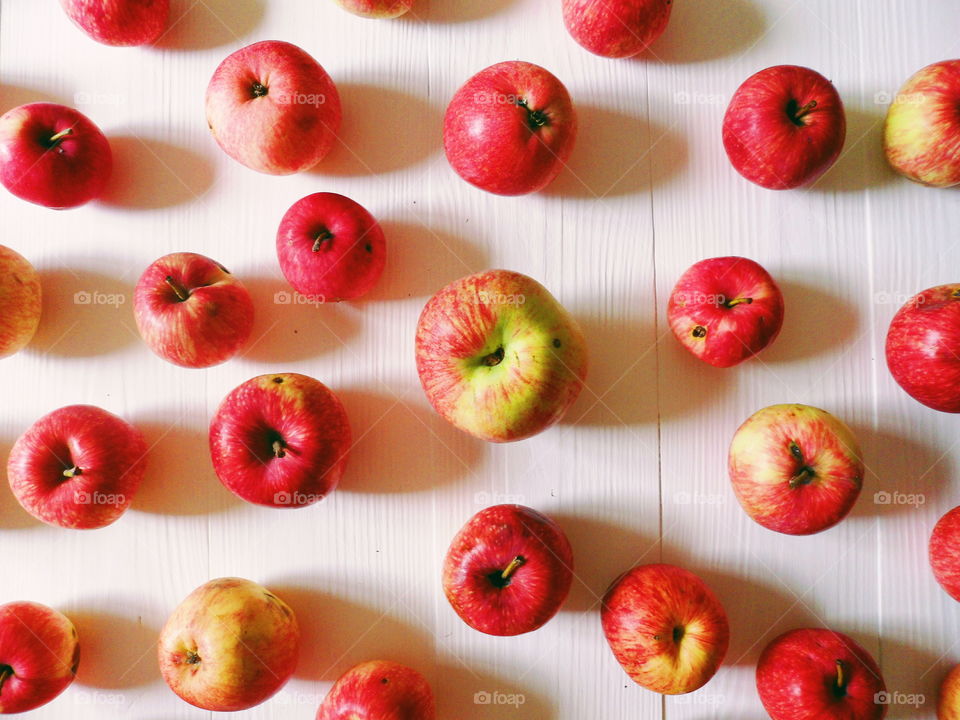 a lot of red apples on a white background