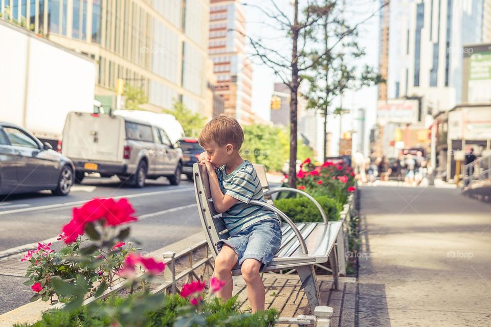 sad little boy on the street