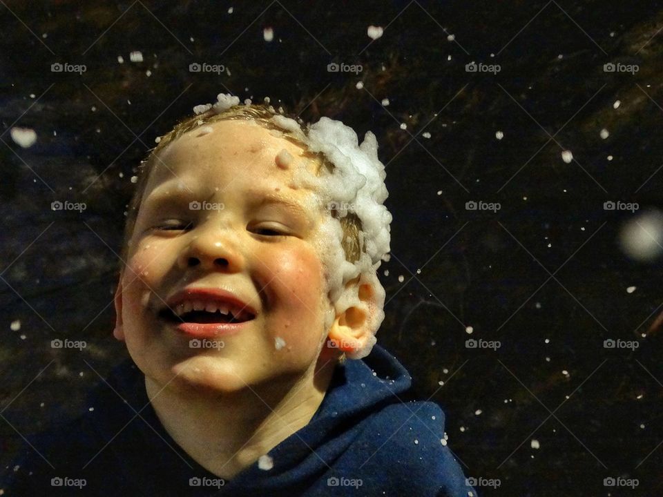 Happy boy in snowfall