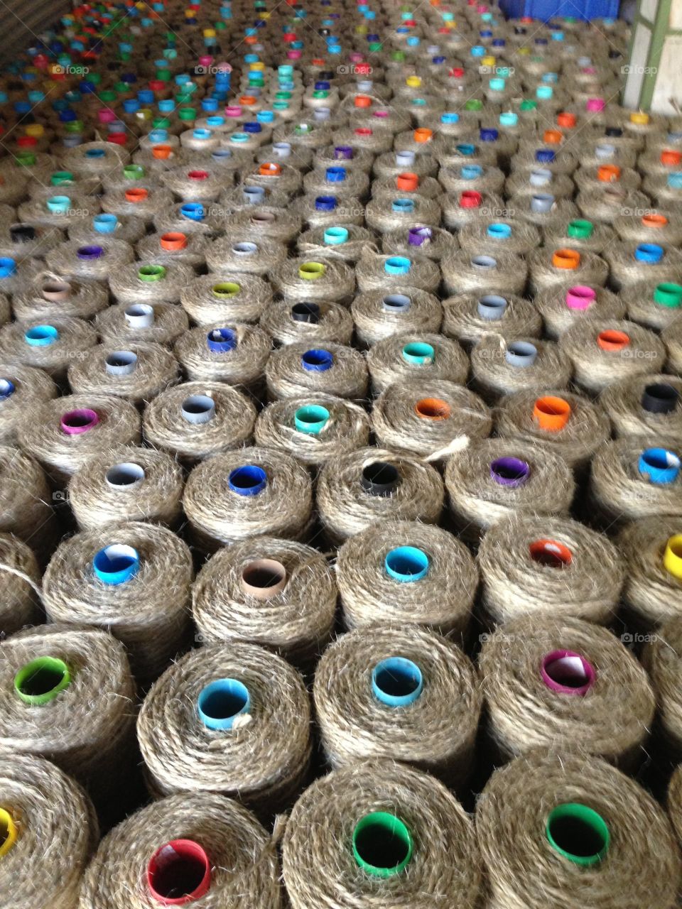 jute spools in home decor factory producing rugs, international travel to tour manufacturers