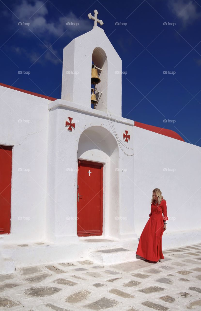 Girl in a red dress near the temple