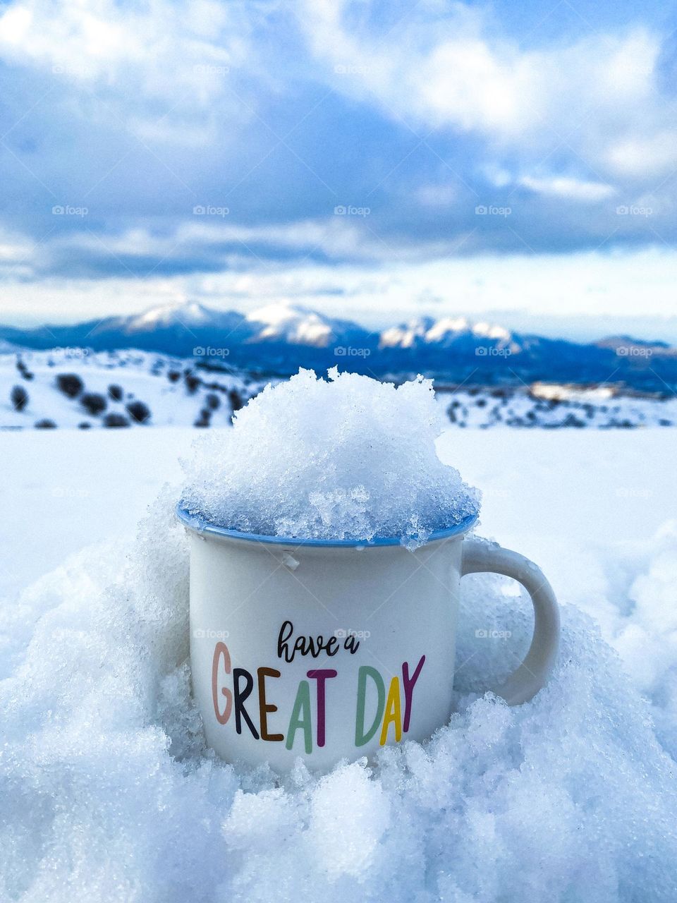 Yea cup full of snow in the mountains