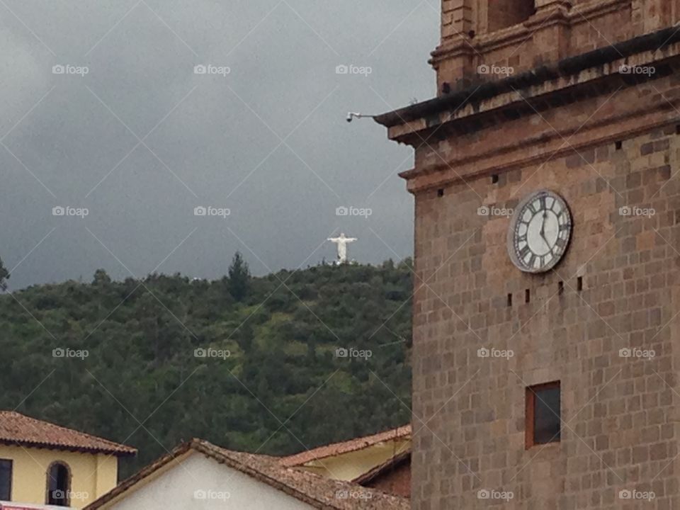 Christ On the Hill. Statue of Christ can be seen in the distance from the city of Cusco, Peru