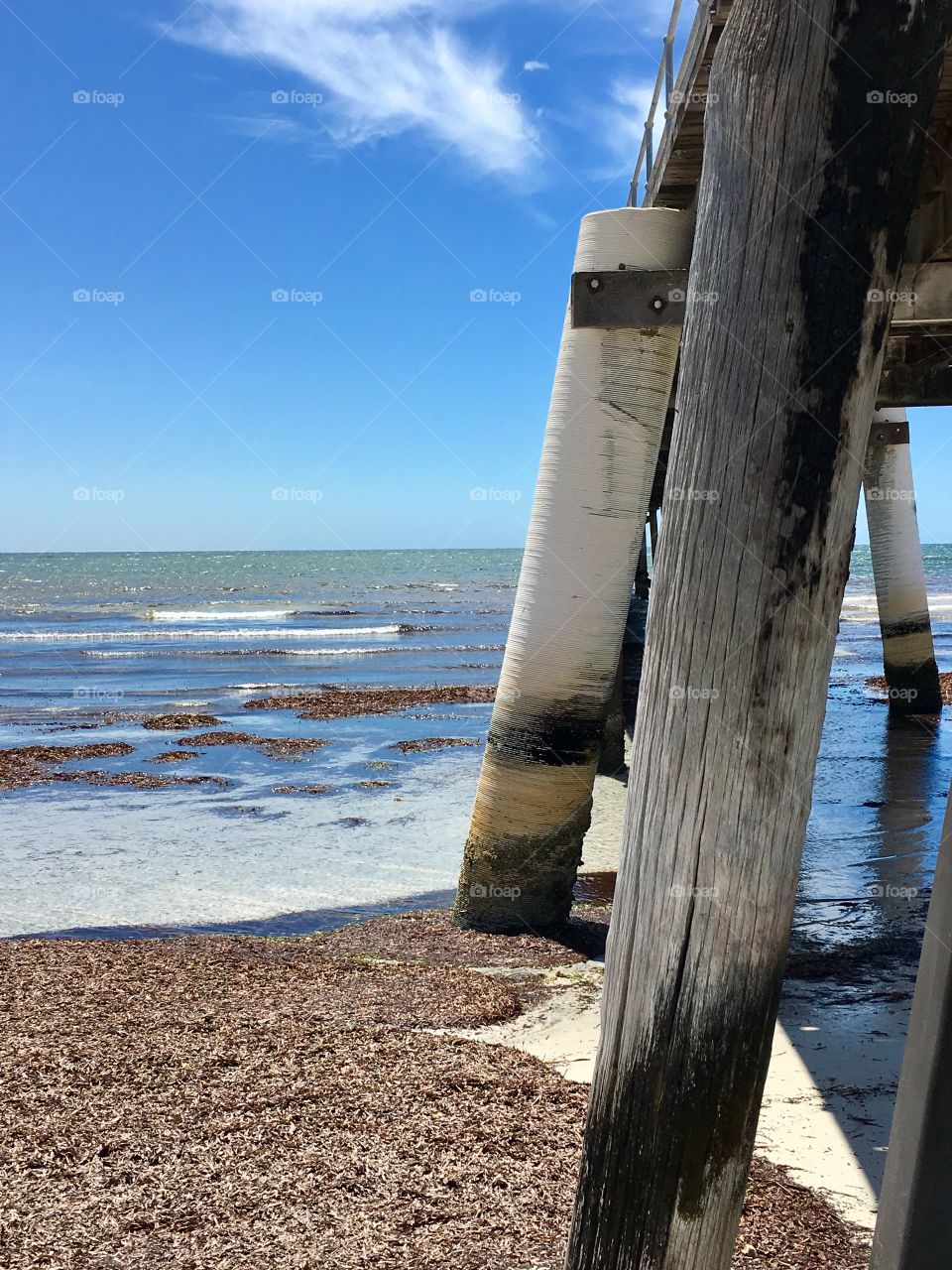 Side view public Jetty wharf out to the ocean 