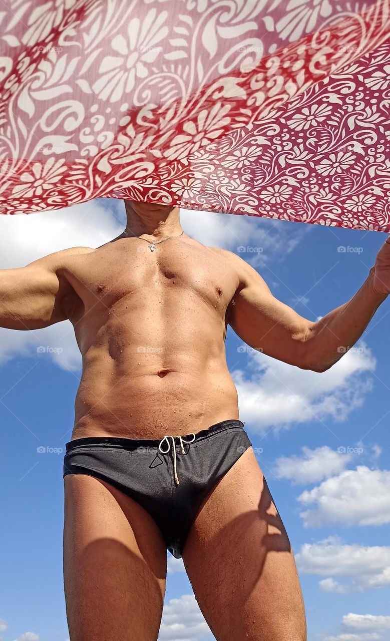 body men in swimming trunk outside blue sky background, summer vacation