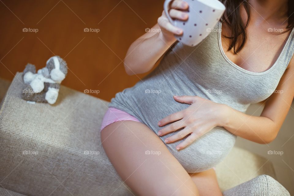 Pregnant woman holding tea cup