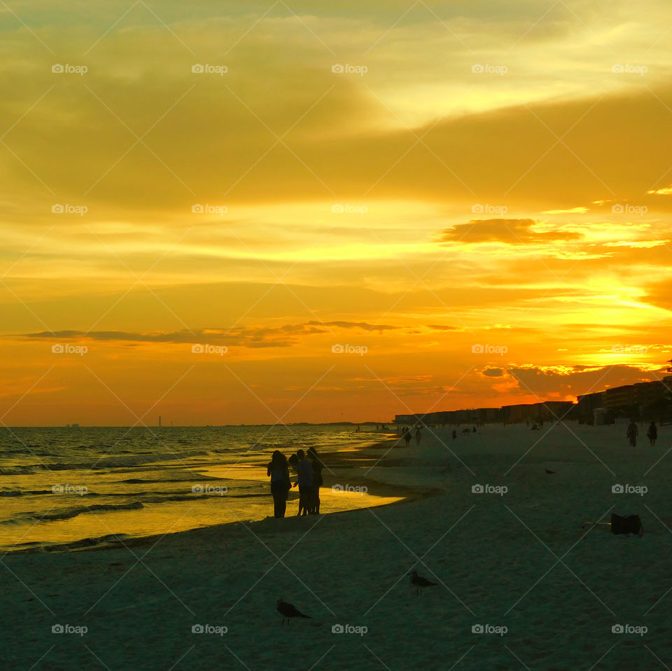 The sun  shone brilliantly and the water in the ocean glittered invitingly! A golden glow spread across the sky as the sun chased the dark clouds away! The sunset is free, so go outside and capture it!