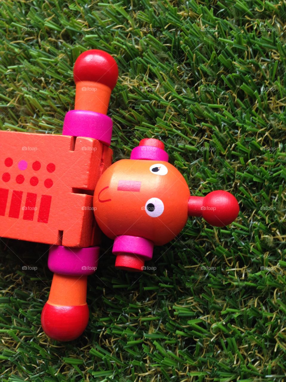 Robot toy left behind on grass