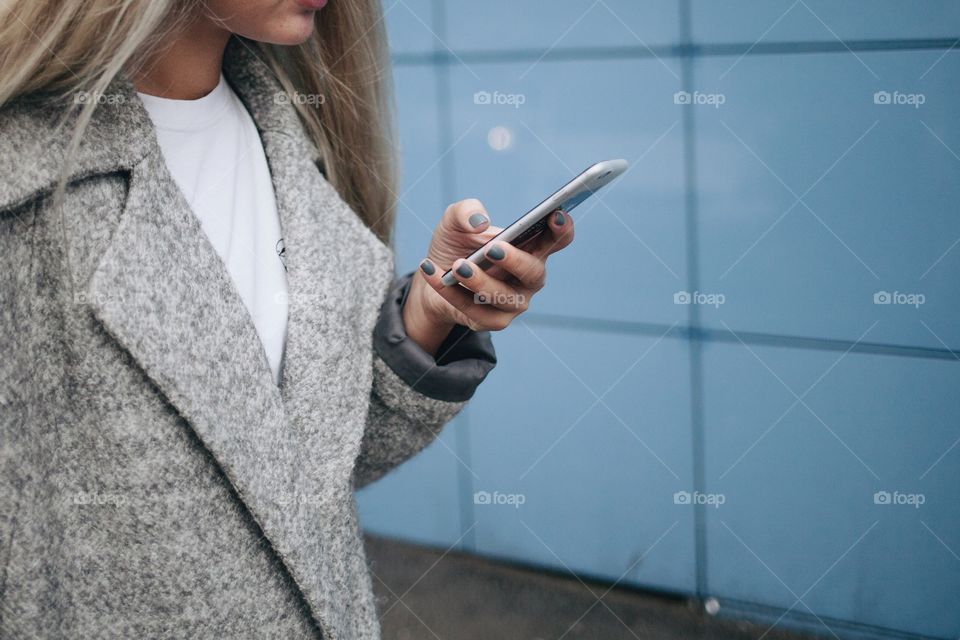 Walking down the street with her phone