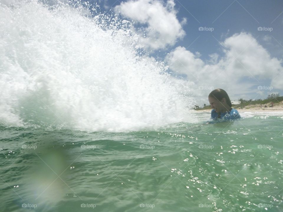 Waves crashing on girl