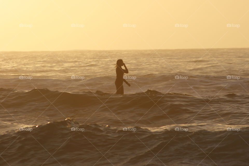Silhouette of a woman standing in sea