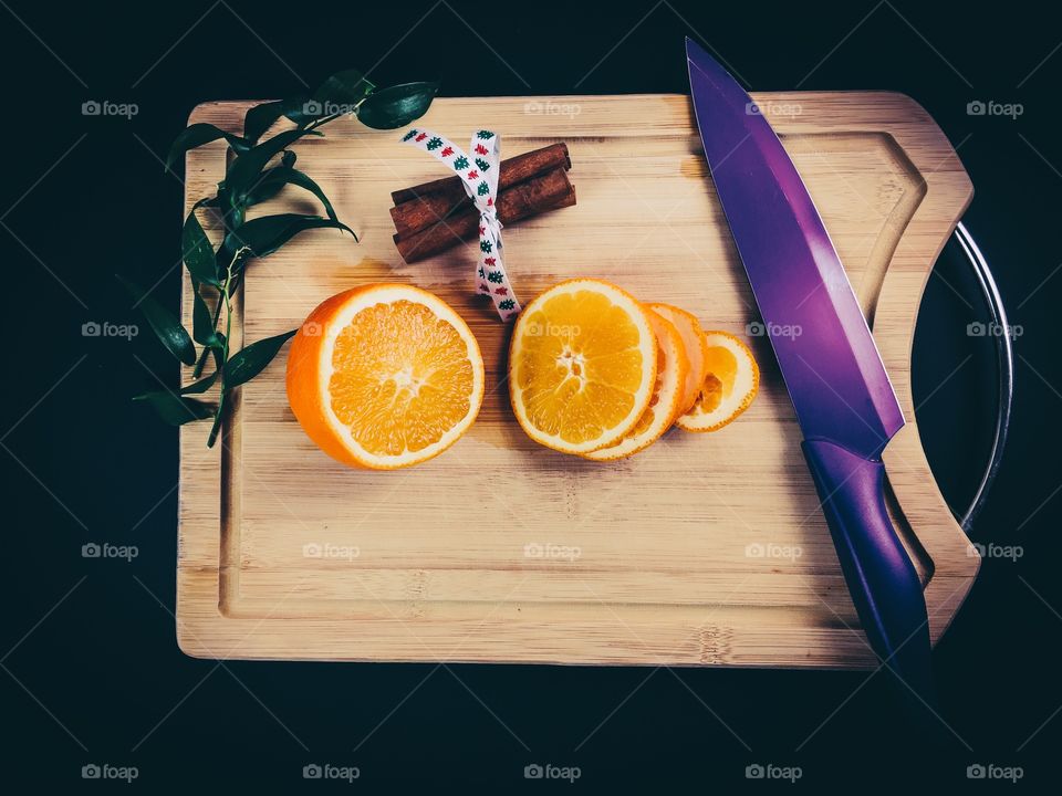 Orange slice and cinnamon on cutting table