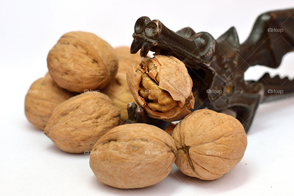 Nutcrackers and walnuts on white background