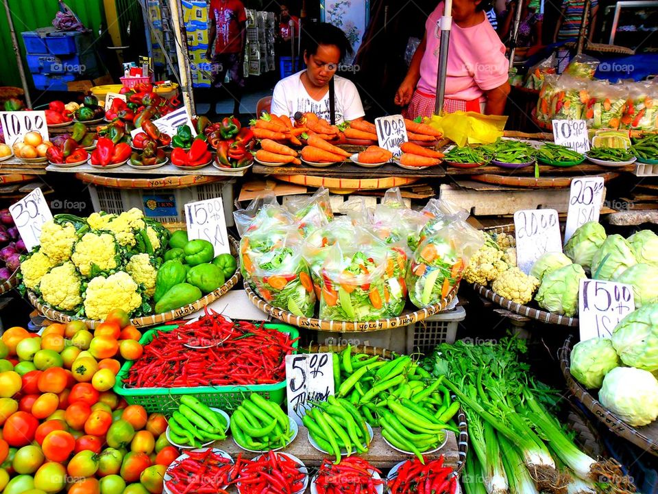 asian street vendor selling fruits and vegetables in quiapo, manila, philippines in asia