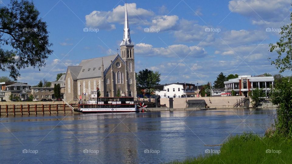 Riverboat in front of a church