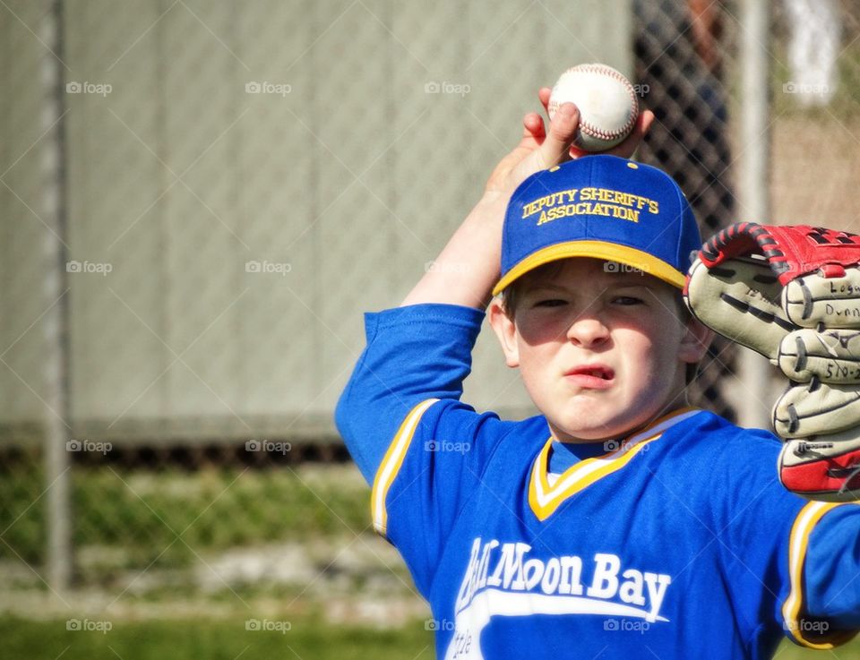 Young Baseball Player Throwing A Baseball
