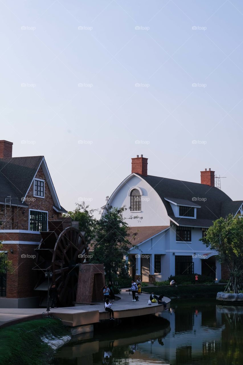 European houses with water mill and trees