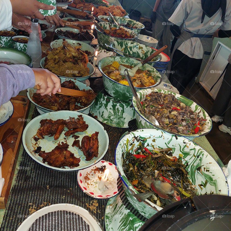 Lunch menu at an outdoor cafe in Bogor, with traditional Indonesian dishes.  customers take their own food