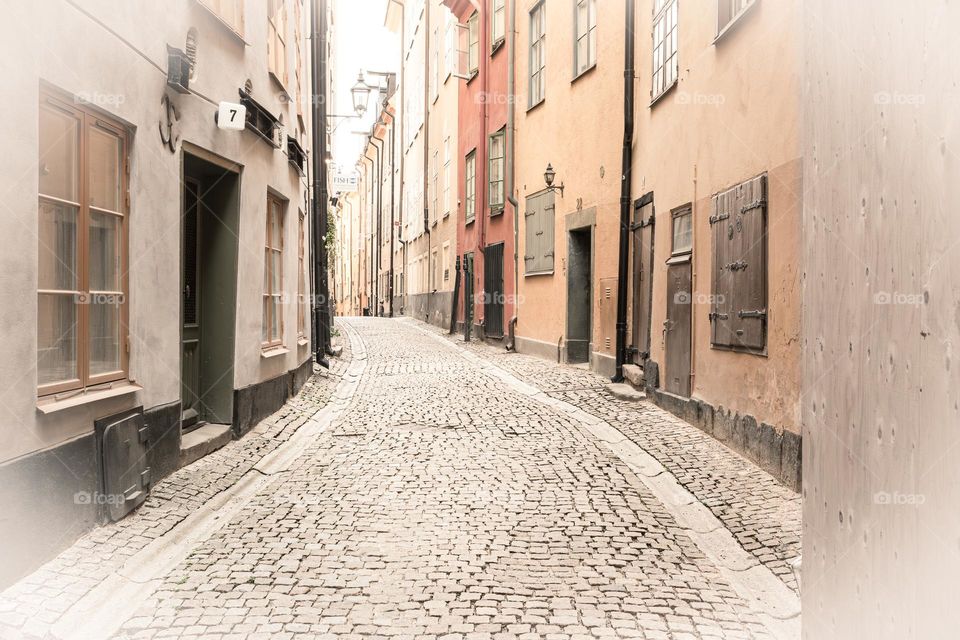 Street with cobblestone and houses in an alley in old town Stockholm Sweden in vintage mood