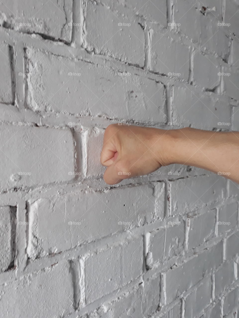 fist on a brick wall
