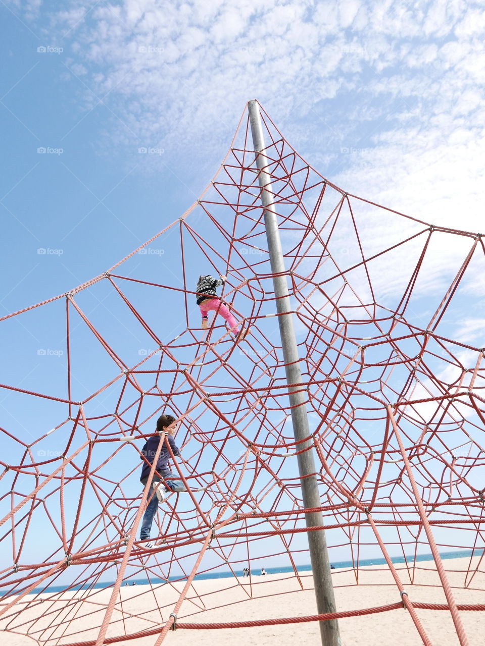 Children playing on jungle gym ropes