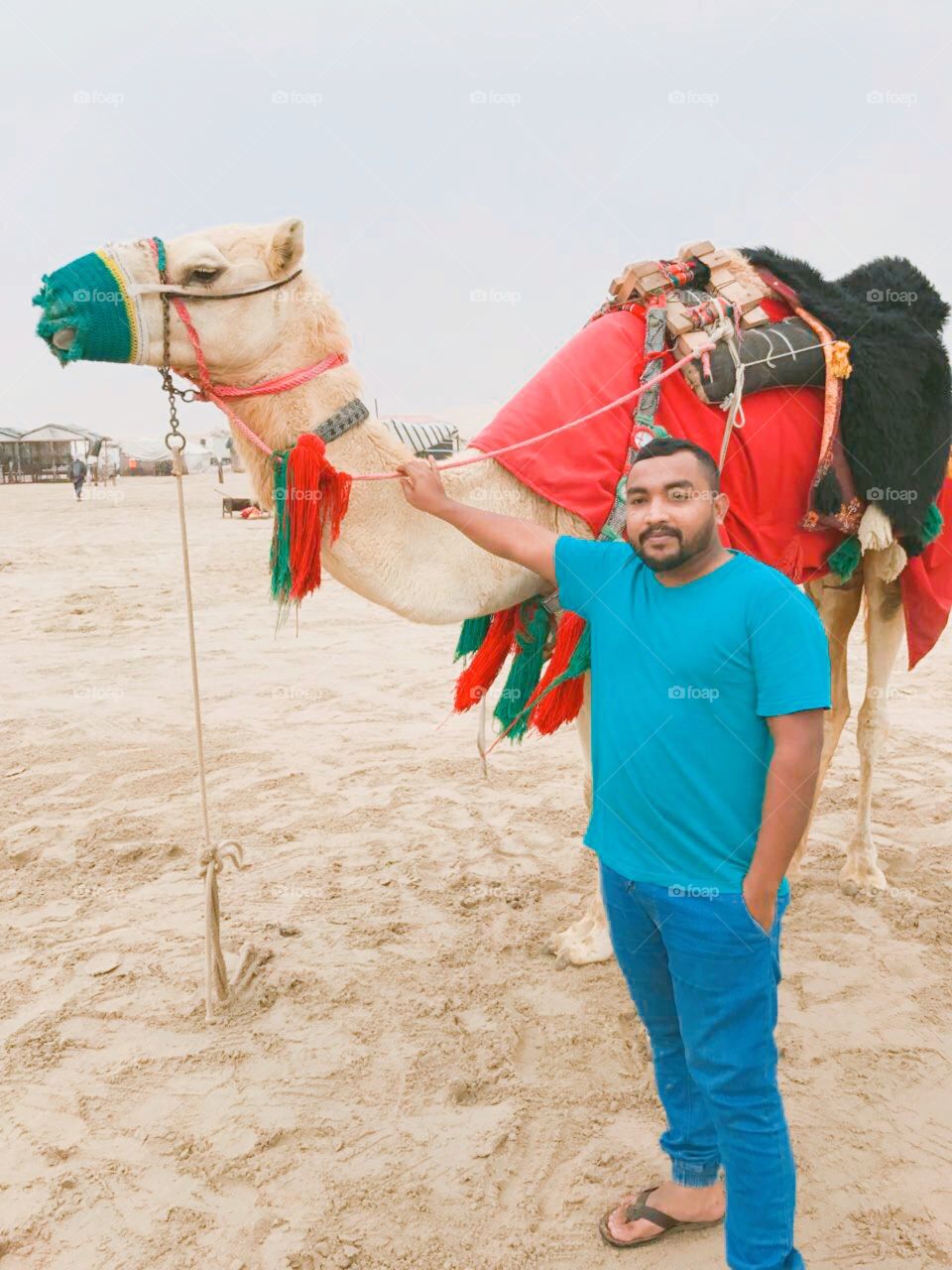 My friend with camel on outing at desert area. 