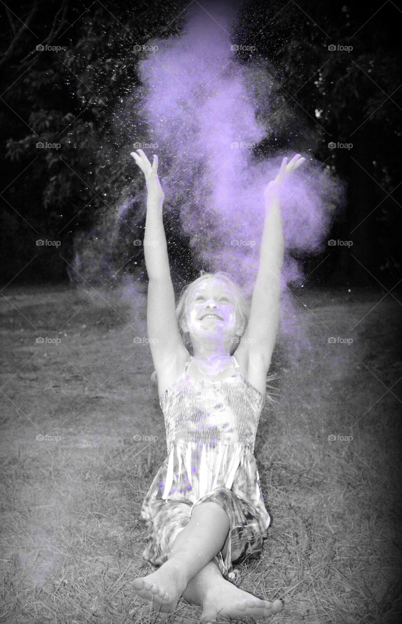Girl splashing powder color in air