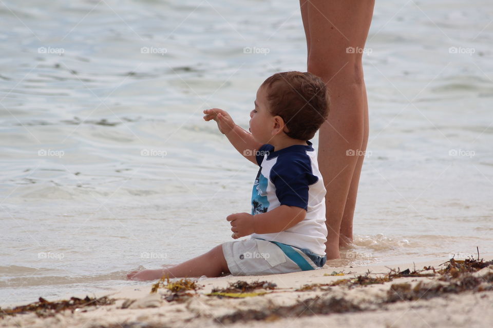 Little Boy Sitting on Beach 