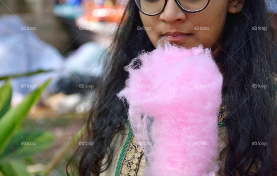 girl having cotton candy