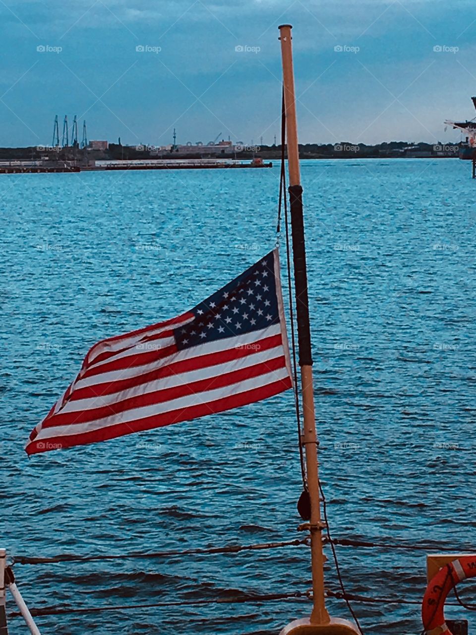 National Ensign proudly flying at half-mast. USCG. 