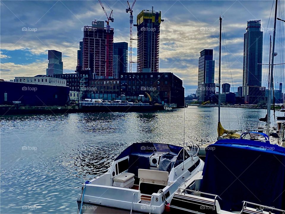 The idyllic “Newtown Creek” seen from the parking lot beneath the “Pulaski Bridge” with its many different kinds of boats photographed on a late afternoon in April 2022. Hypnotic Productions