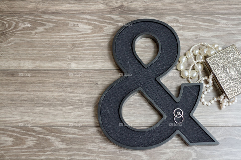 A diamond engagement run and wedding band on a Black ampersand styled with an antique jewelry box and pearls