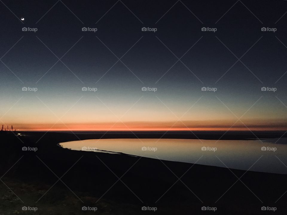 Moon and Sunset together in the lagoon 