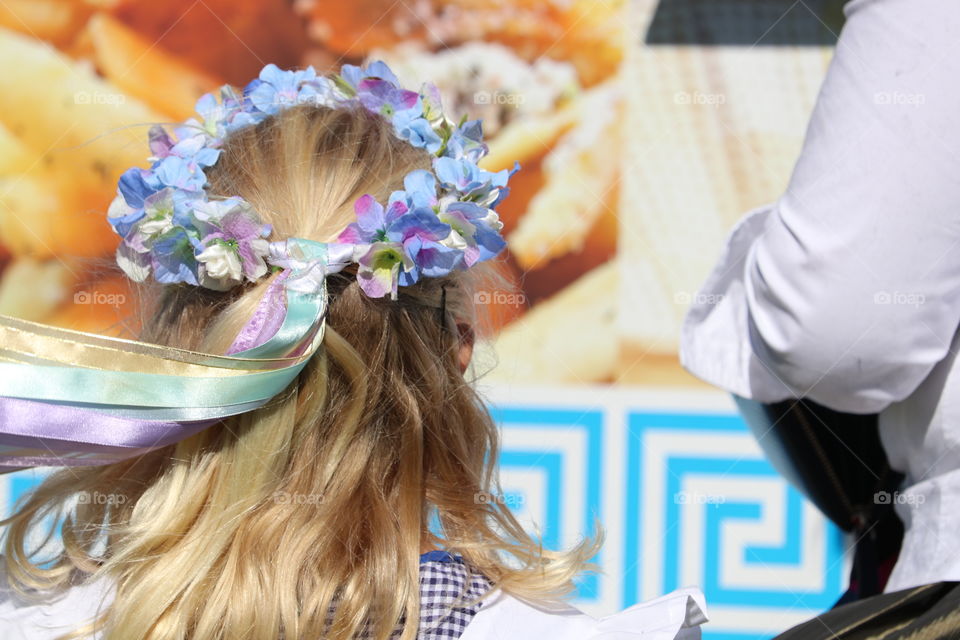 Violet and blue flower crown in hat of young blond girl child in traditional May Day Cornish tradition 