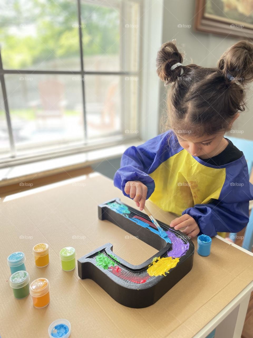 Toddler girl paints letter J, making a present, painting with toddlers, making the letter J, making a gift for Justin, crafting with toddlers 