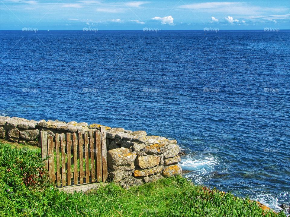 Ocean Gateway. An old wooden gate and dry stone wall provide the gateway to an ocean view.