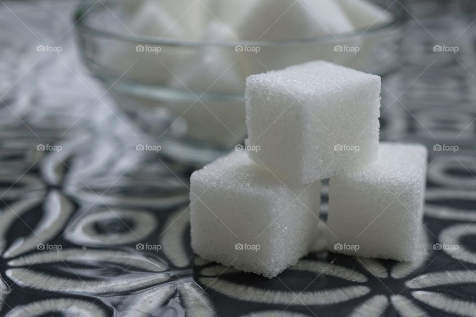 Stacked Sugar Cubes on a grey patterned plate 