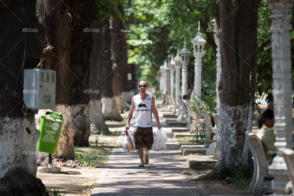 Man with shopping bag in the park