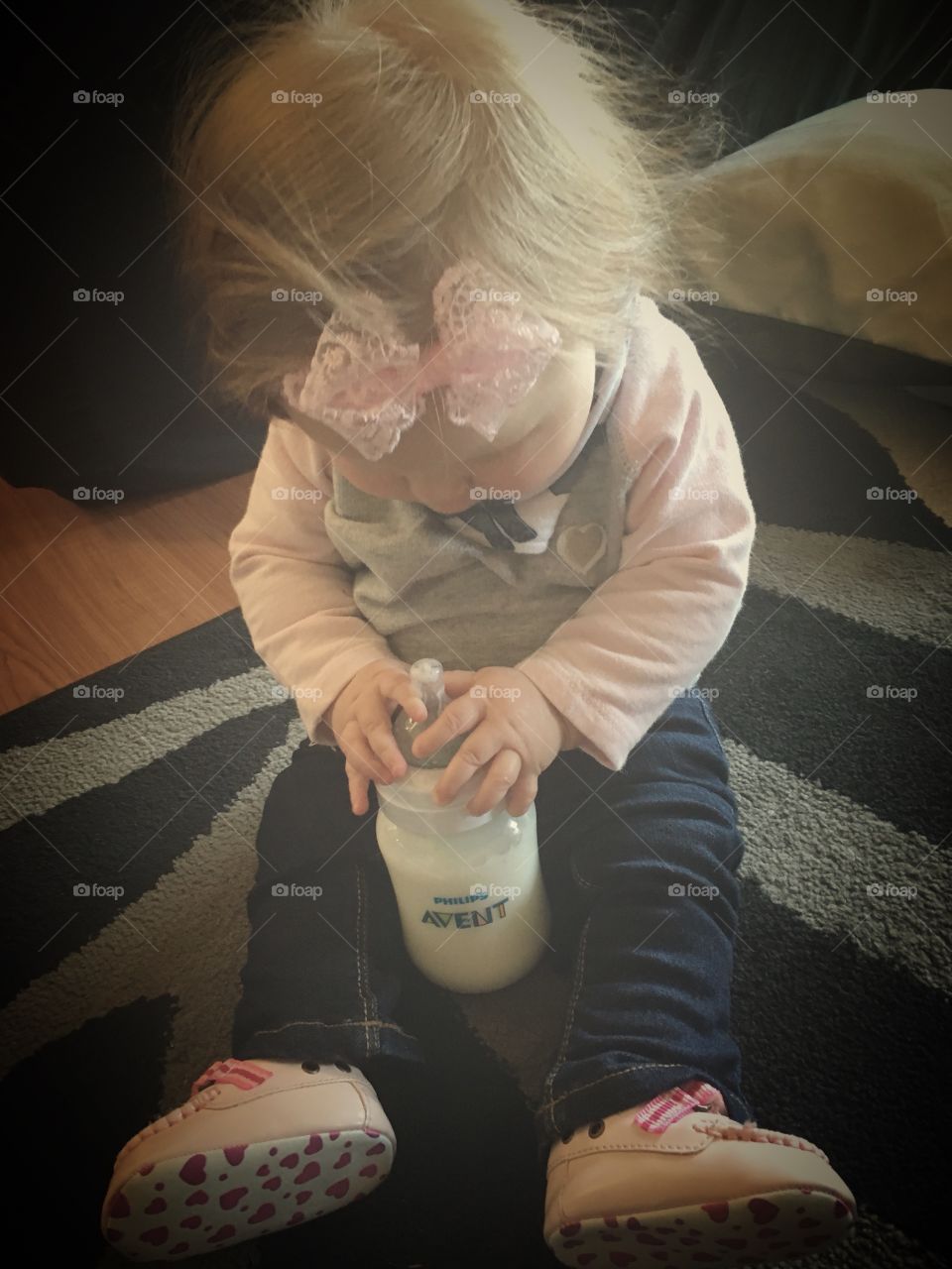 Baby holding bottle