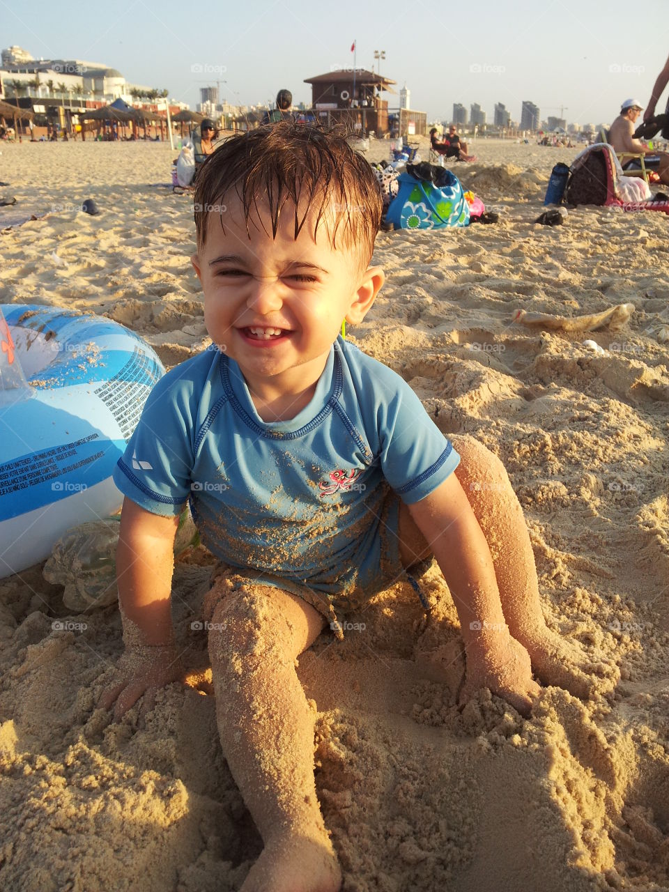 fun face. boy meke fun face on the beach