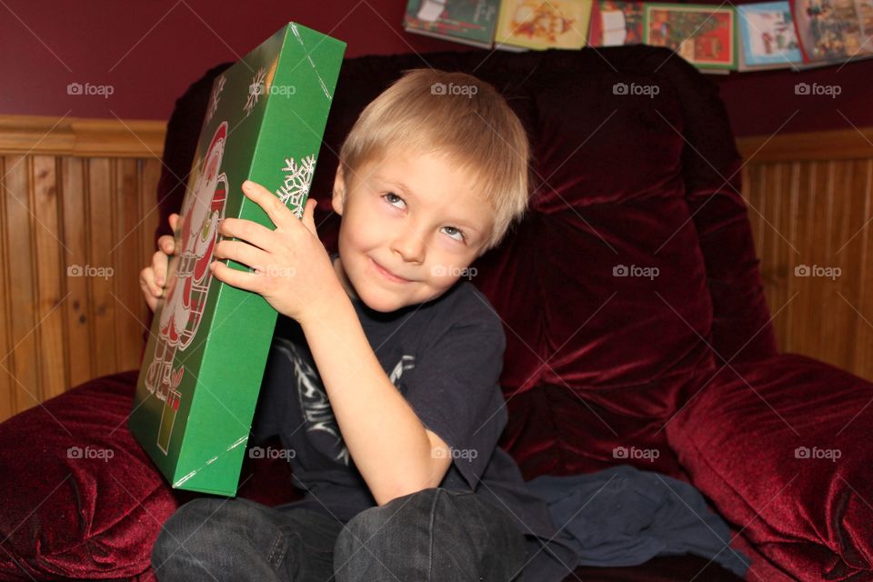 Little boy holding gift box in hand