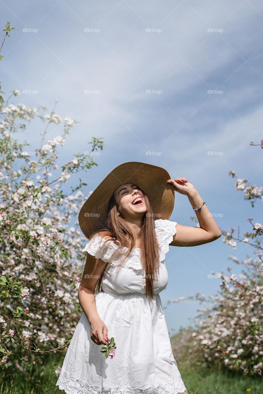 beautiful woman in spring blossom trees