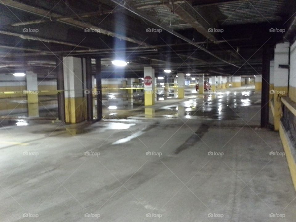 Wet parking lot. Still under construction after many years.