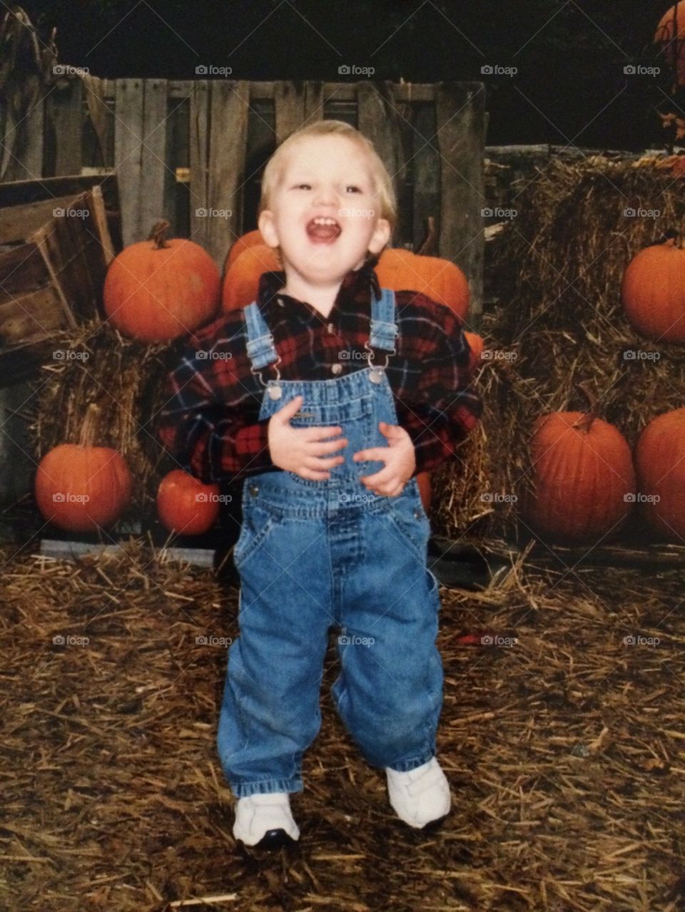 Boy In pumpkin patch