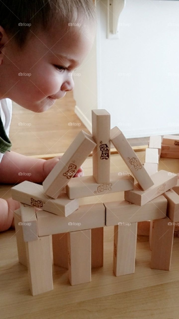 Toddler with Building Blocks (Jenga)