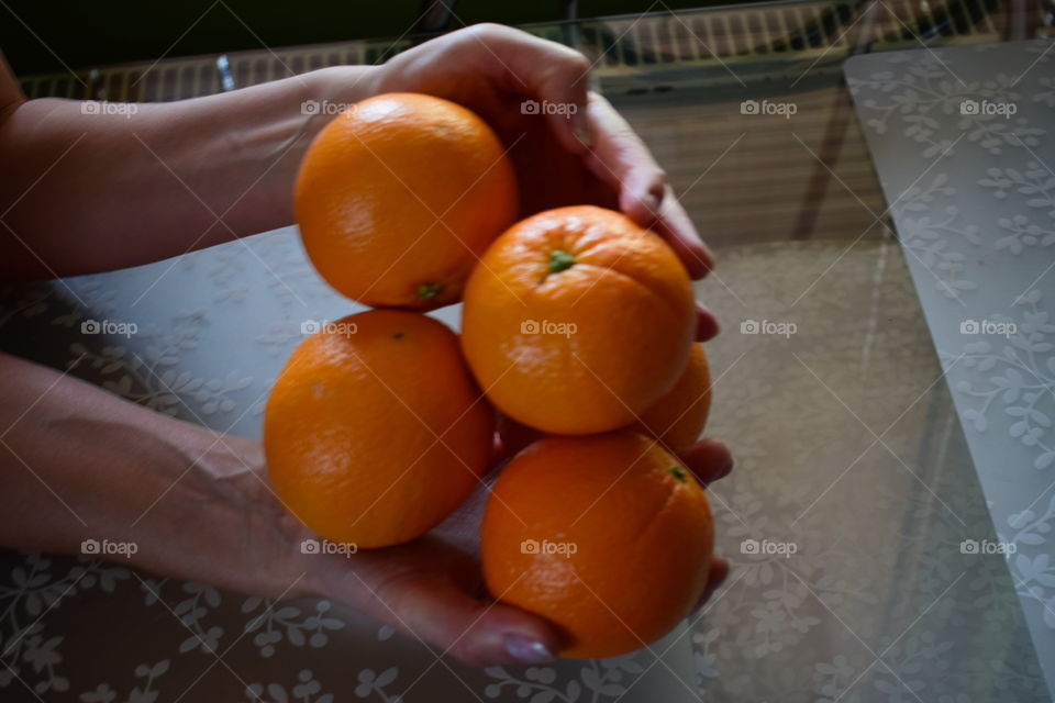 Orange , hand ,table vitamin