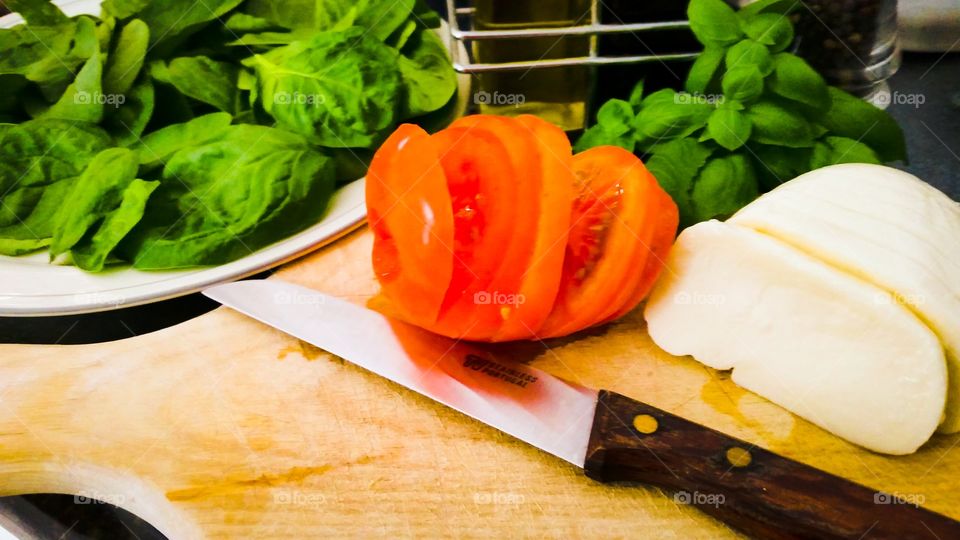 Preparing caprese salad