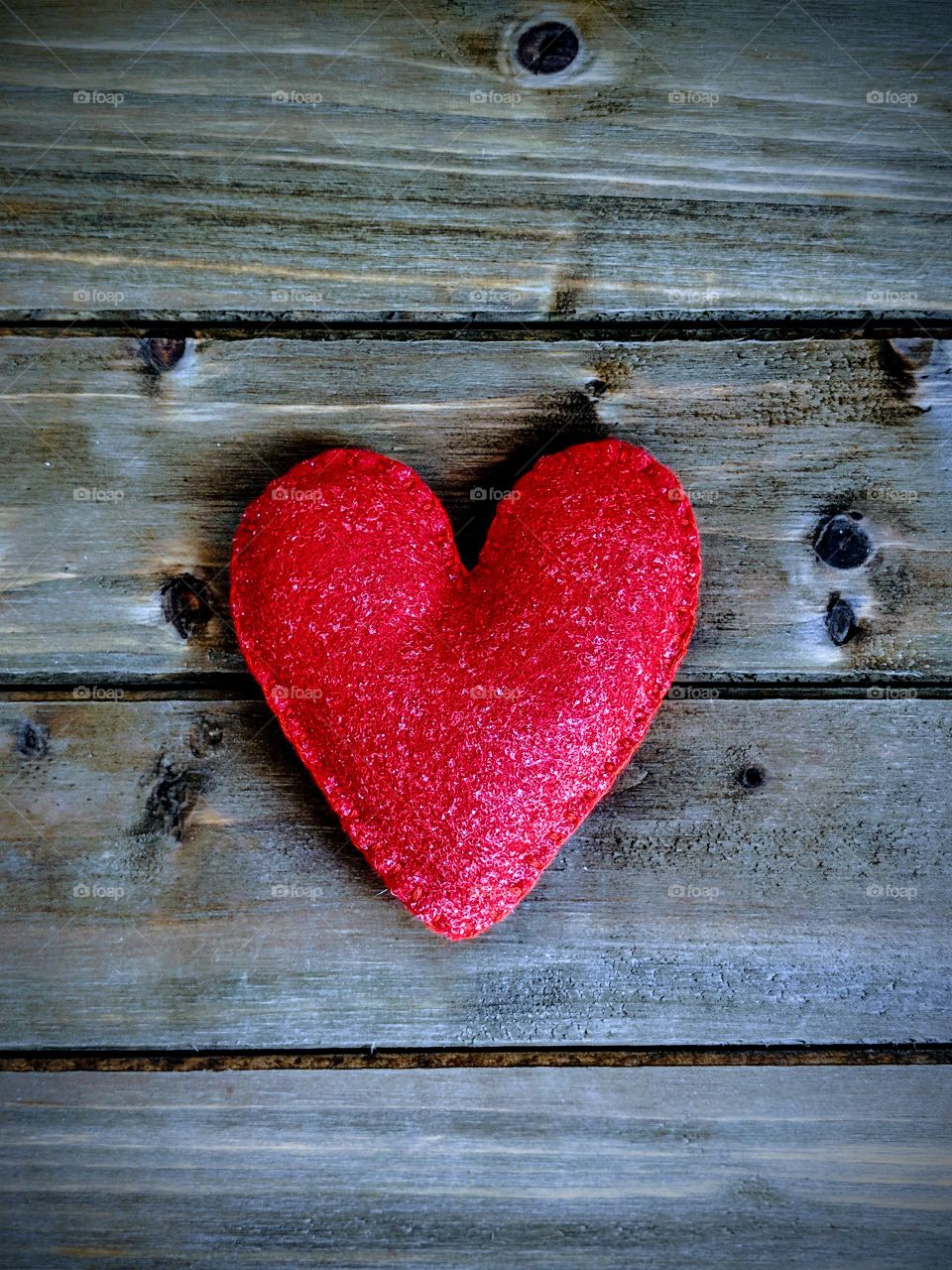 A red heart on a wooden background