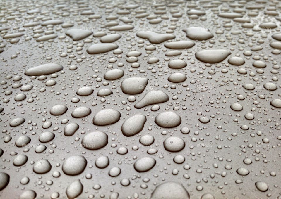 Raindrops on my Chevy. Raindrops beading on the roof of my freshly waxed Chevy Malibu.