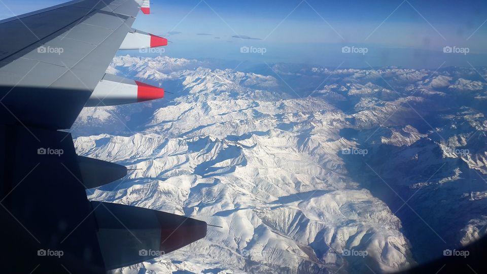 Beautiful mountian flight: stunning view from the airplane. Flight from Malta to United kingdom, via Switzerland and France